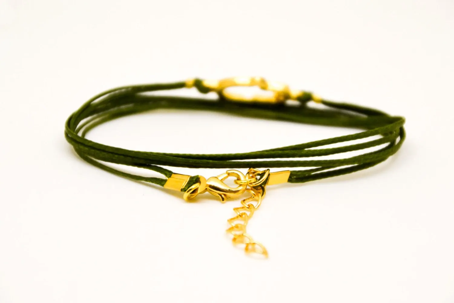 Wrapped green cord bracelet with gold Hamsa charm