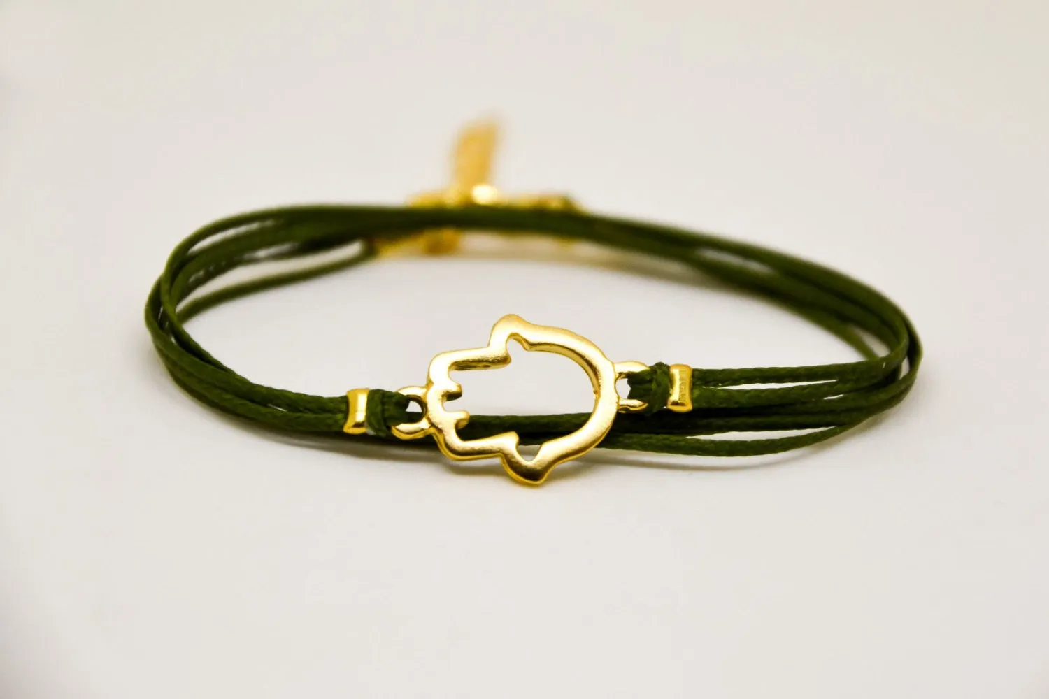 Wrapped green cord bracelet with gold Hamsa charm